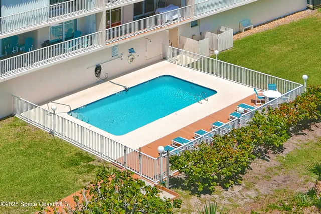 a view of staircase with railing and a window