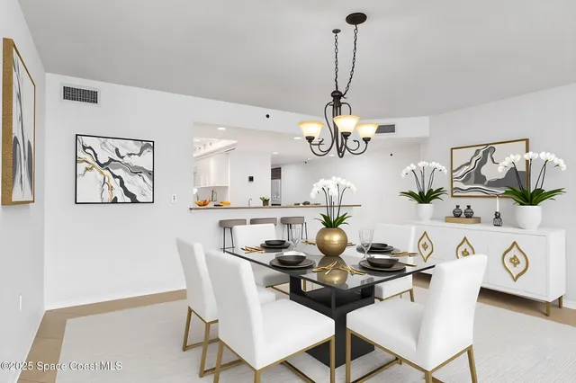 a kitchen with granite countertop a white refrigerator oven a sink dishwasher and white cabinets with wooden floor