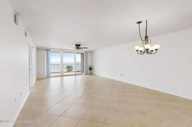 a kitchen with a sink granite counter tops and a view of living room