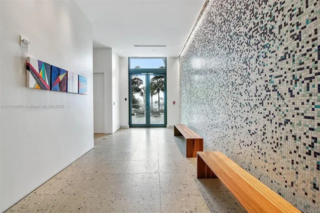 a room with pool table and windows