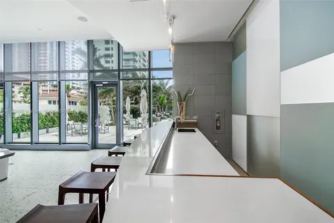 a bathroom with a window and shower curtain