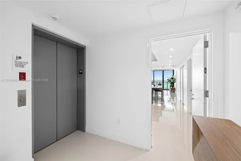 a large kitchen with a table and chairs