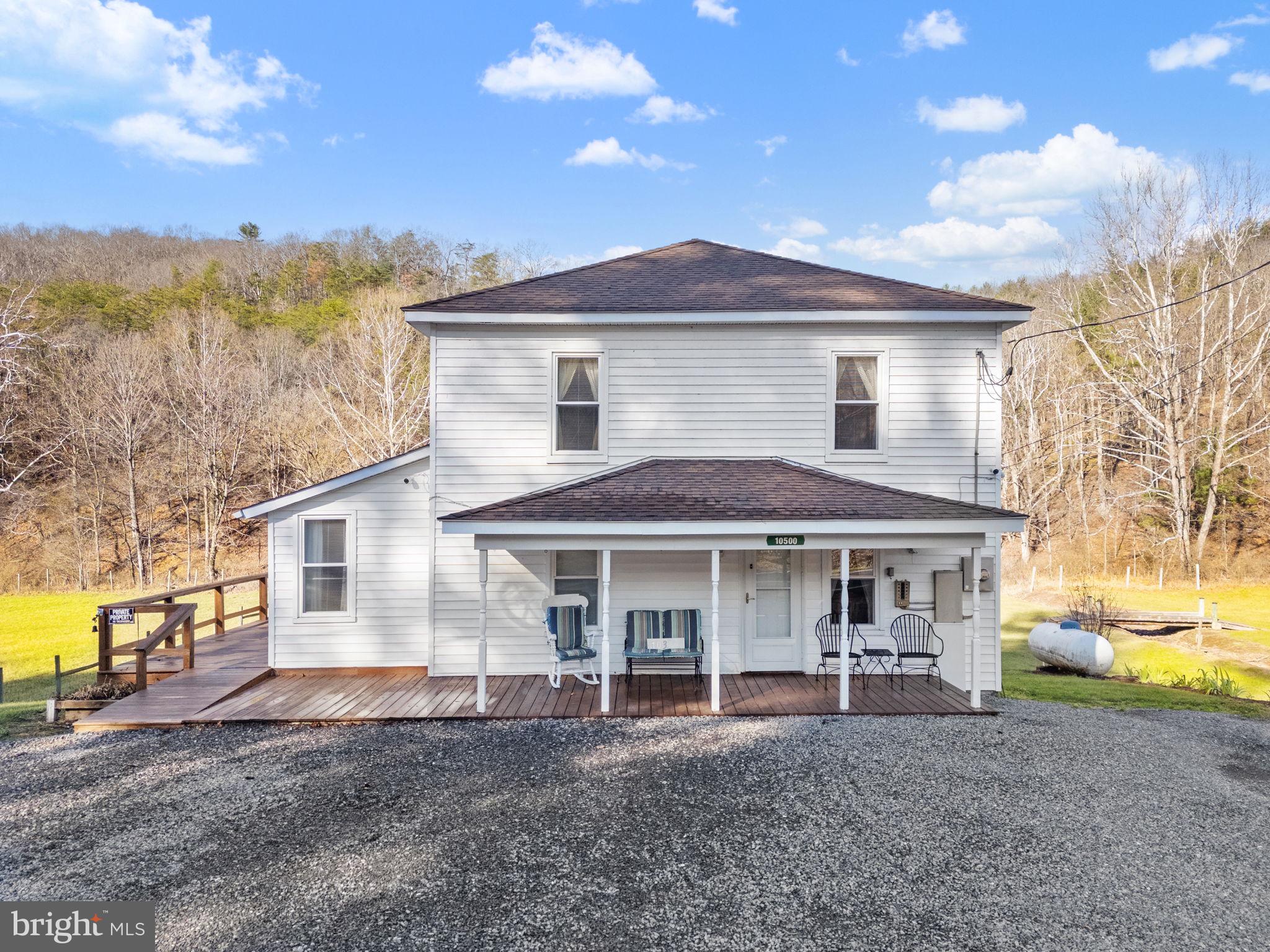 10500 Ford Hill Road Rio, WV 26755 - Photo 1 of 59 a front view of a house with a garden