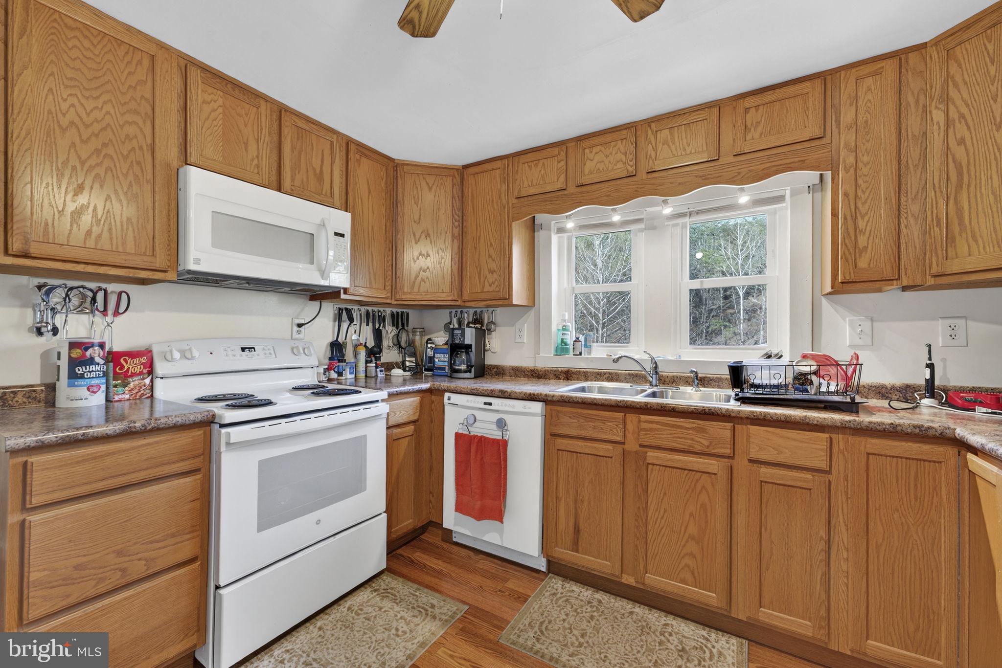 10500 Ford Hill Road Rio, WV 26755 - Photo 11 of 59 a kitchen with cabinets appliances a sink and a window