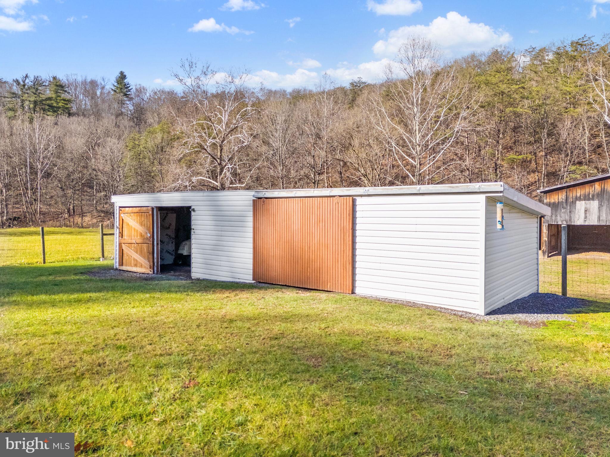 10500 Ford Hill Road Rio, WV 26755 - Photo 33 of 59 a view of a house with a backyard and trees