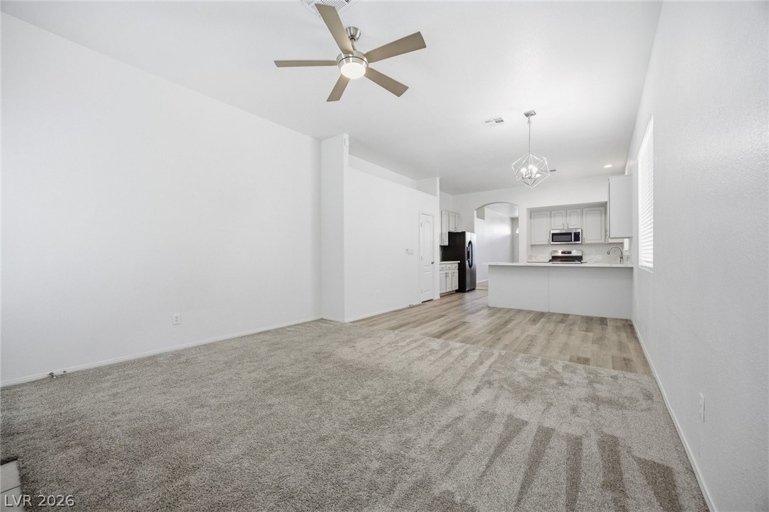 193 Oella Ridge Court Henderson, NV 89012 - Photo 12 of 32 An open-concept living area flows into a well-appointed kitchen, ideal for effortless entertaining.
