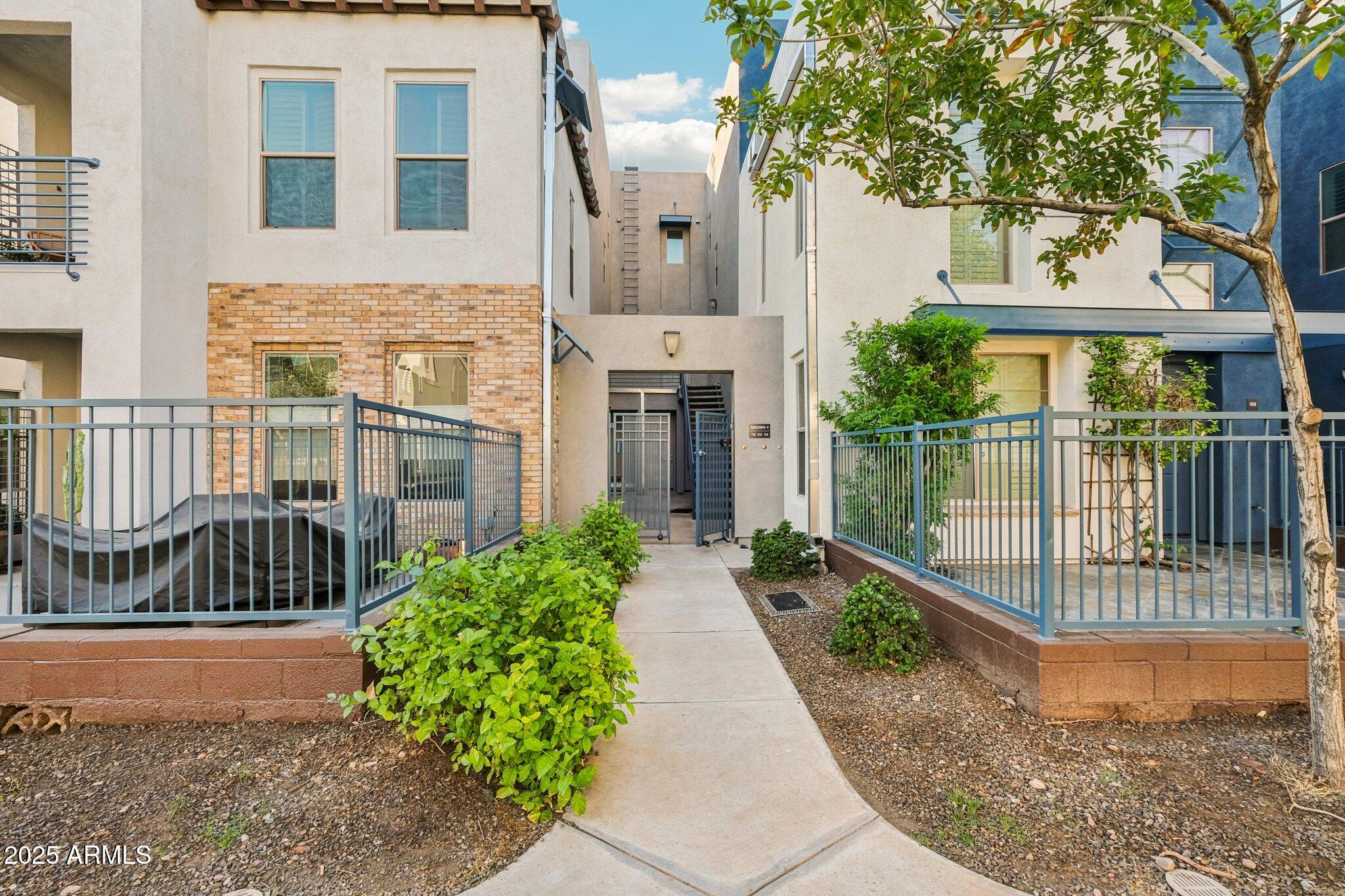 615 East Portland Street, Unit 115 Phoenix, AZ 85004 - Photo 1 of 32 a front view of a house with a garden