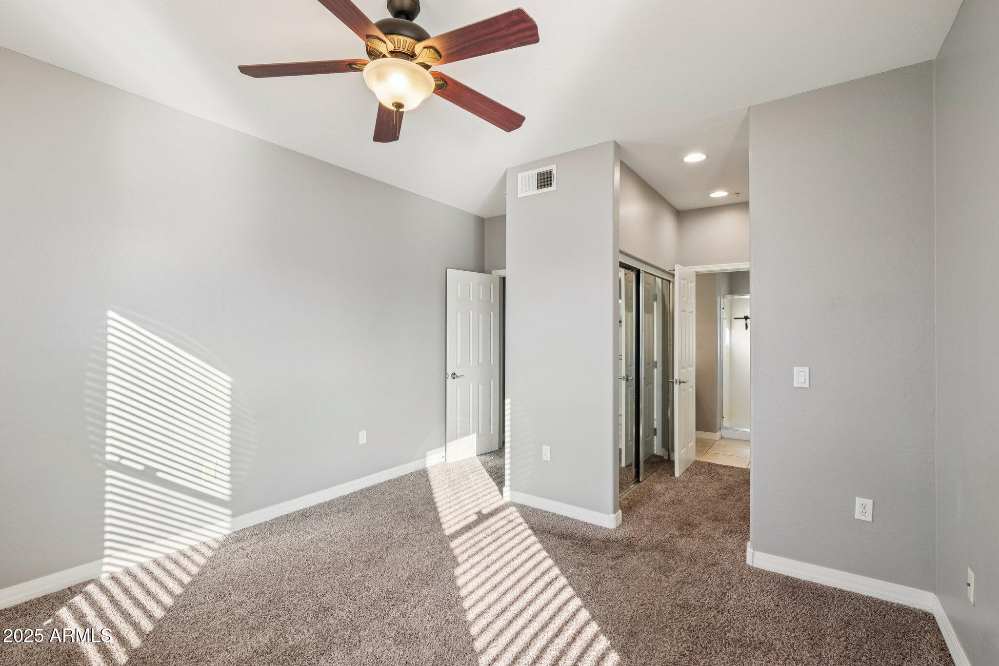 615 East Portland Street, Unit 115 Phoenix, AZ 85004 - Photo 10 of 32 a view of a livingroom with a chandelier fan and wooden floor