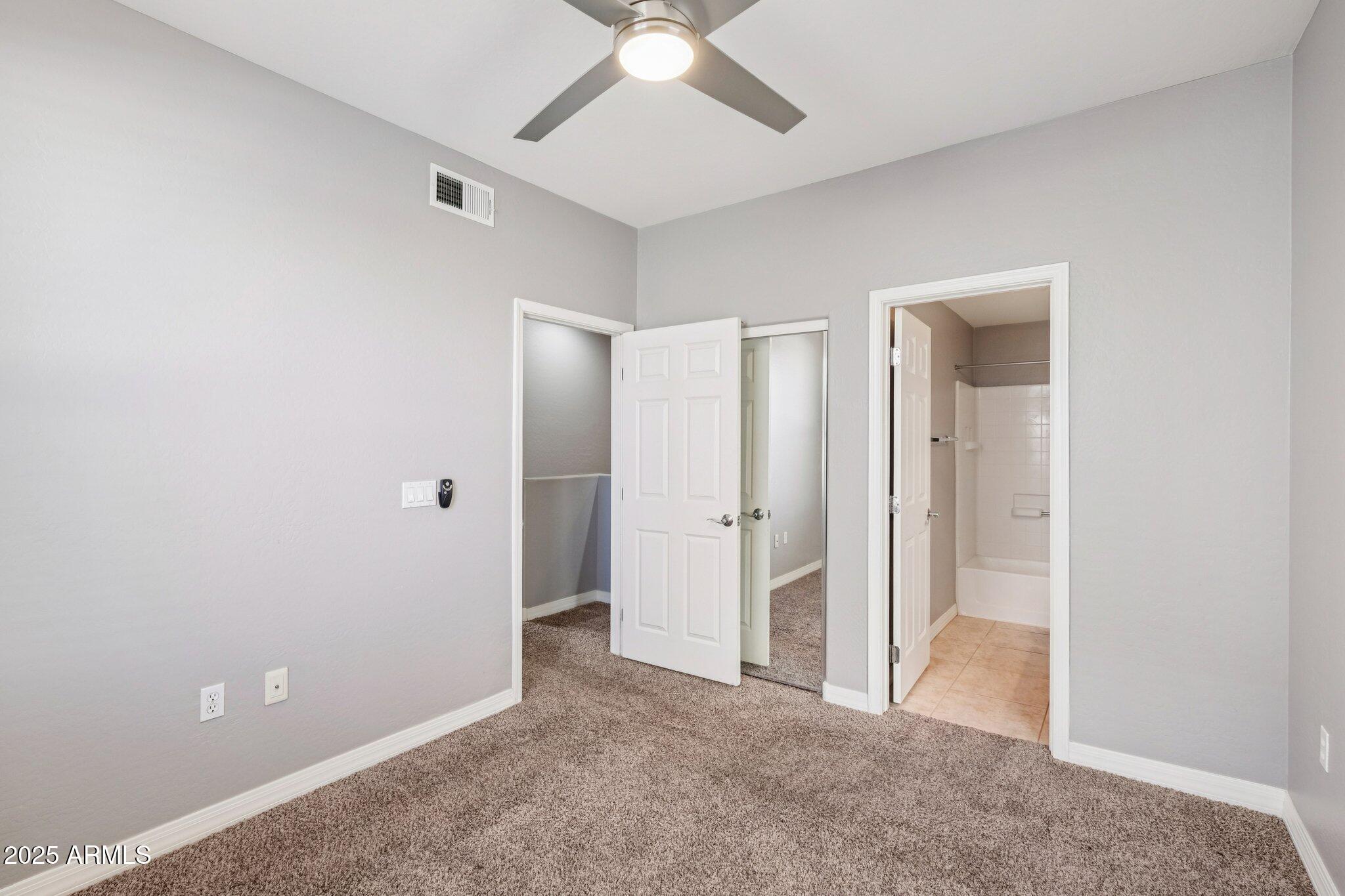 615 East Portland Street, Unit 115 Phoenix, AZ 85004 - Photo 12 of 32 an empty room with closet and a ceiling fan