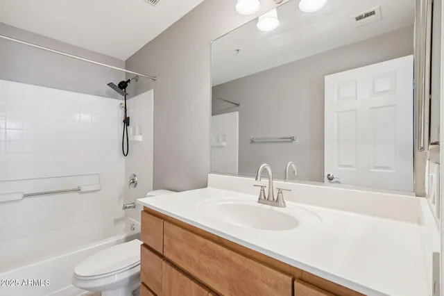 a bathroom with a sink vanity granite tub and shower