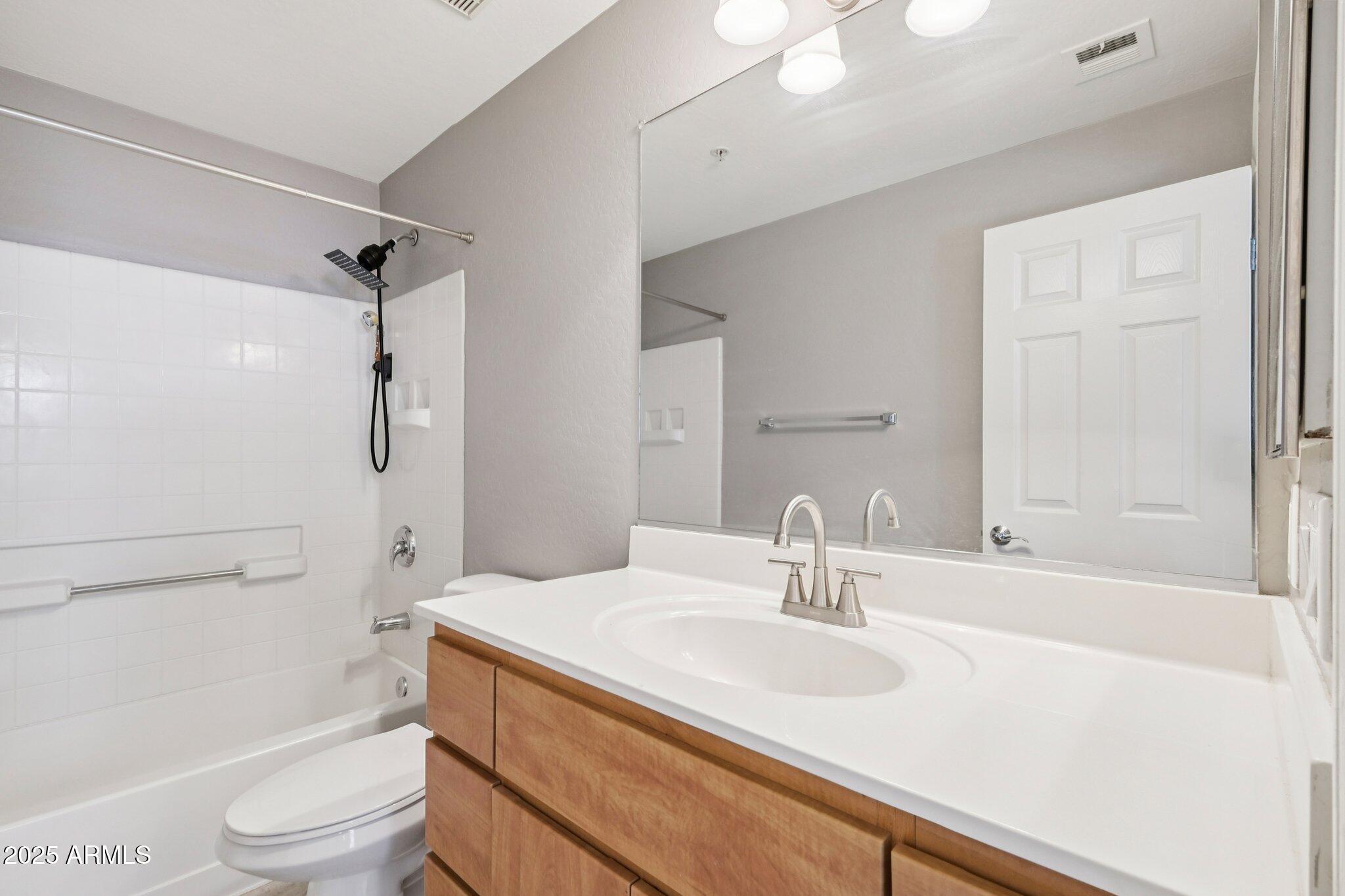 615 East Portland Street, Unit 115 Phoenix, AZ 85004 - Photo 16 of 32 a bathroom with a sink toilet vanity and shower