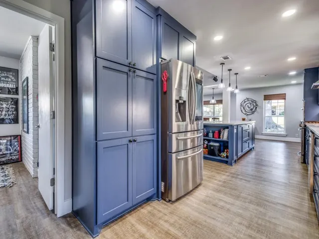 a kitchen with stainless steel appliances granite countertop sink microwave and wooden floor