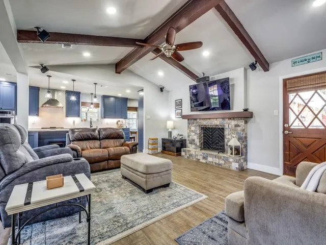 a living room with lots of furniture and kitchen view