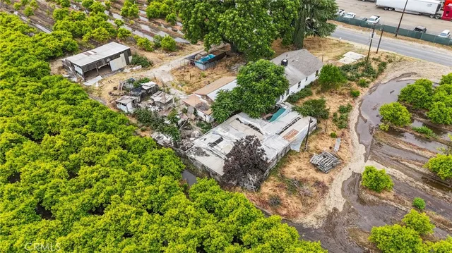 an aerial view of a house with a yard and trees