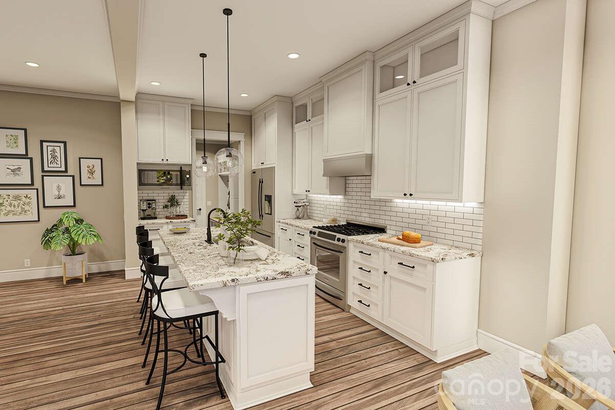 2031 Piper Ridge Drive Lenoir, NC 28645 - Photo 8 of 19 a large kitchen with stainless steel appliances kitchen island granite countertop a table chairs in it and wooden floors