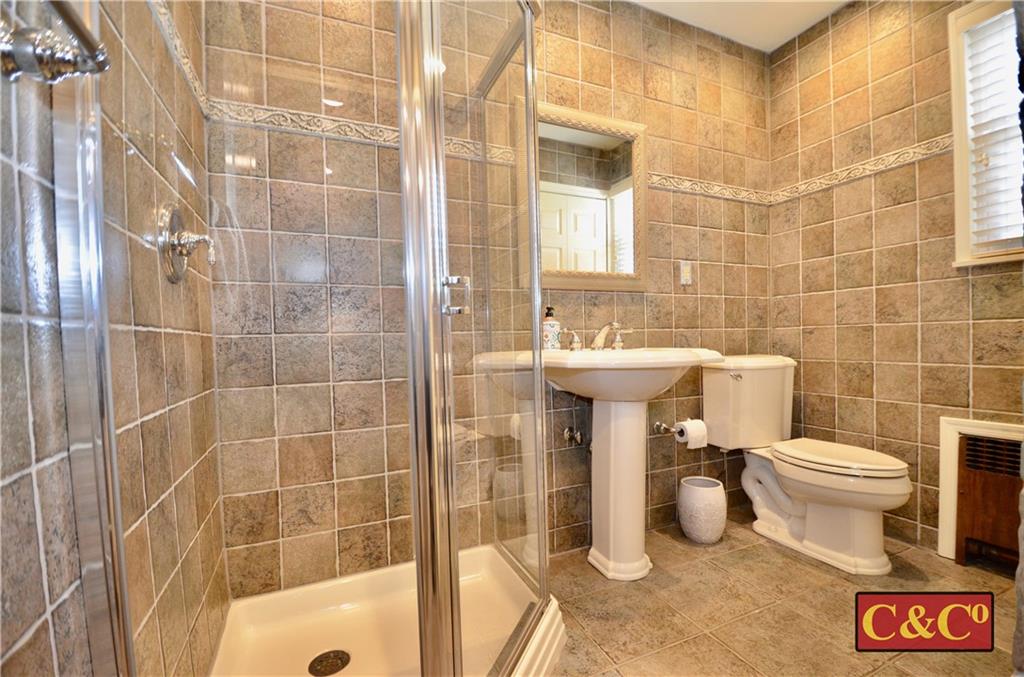 8 Oak Street Valley Stream, NY 11581 - Photo 12 of 40 a bathroom with a sink toilet and shower