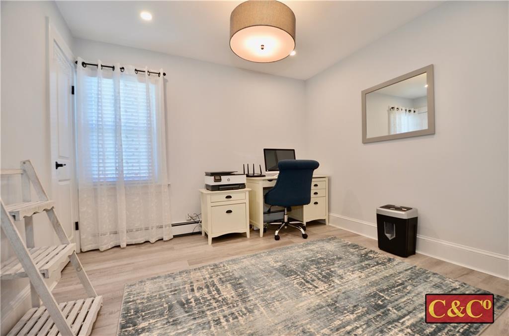 8 Oak Street Valley Stream, NY 11581 - Photo 17 of 40 a view of a workspace with furniture and a window