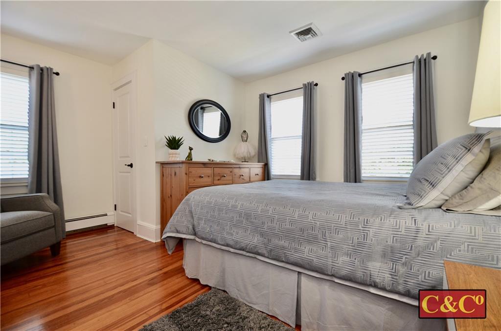 8 Oak Street Valley Stream, NY 11581 - Photo 18 of 40 a bedroom with a bed and wooden floor