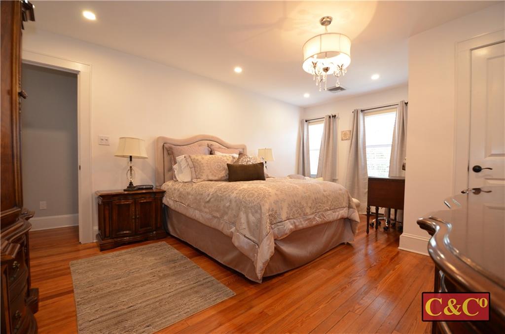8 Oak Street Valley Stream, NY 11581 - Photo 20 of 40 a bedroom with a bed and wooden floor