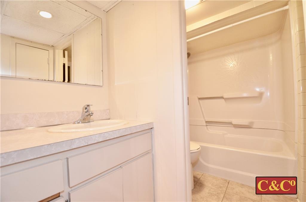 8 Oak Street Valley Stream, NY 11581 - Photo 28 of 40 a bathroom with a granite countertop sink and a mirror