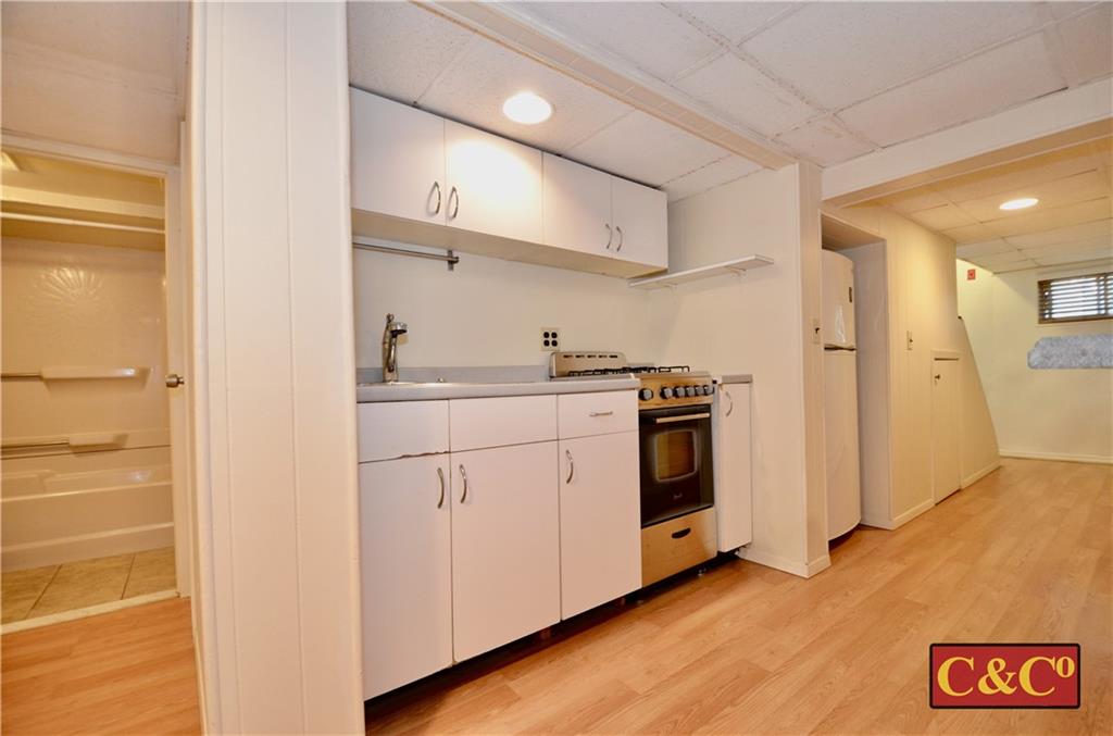 8 Oak Street Valley Stream, NY 11581 - Photo 32 of 40 a kitchen with a sink and a refrigerator