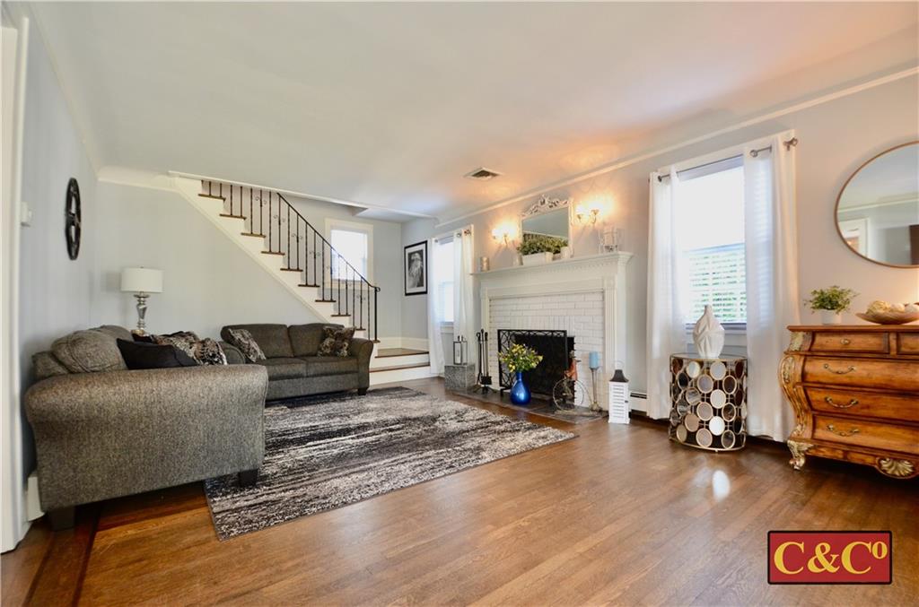 8 Oak Street Valley Stream, NY 11581 - Photo 6 of 40 a living room with furniture and a fireplace