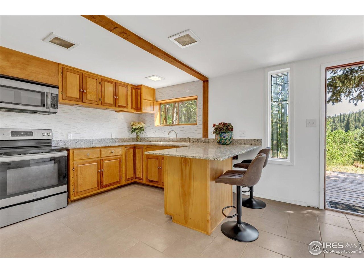 57 Nelson Street Ward, CO 80481 - Photo 5 of 27 a kitchen with a sink cabinets and window