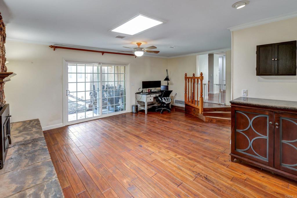 11985 Rocoso Road Lakeside, CA 92040 - Photo 15 of 48 a view of a livingroom with furniture hardwood floor and a flat screen tv