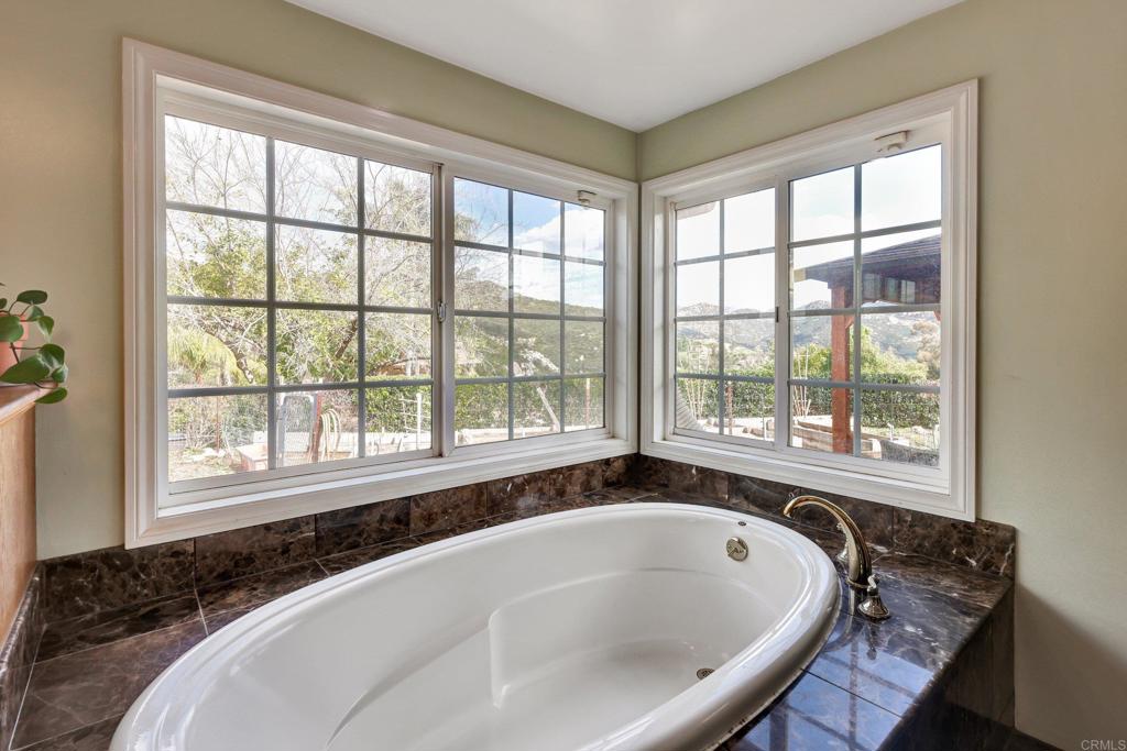 11985 Rocoso Road Lakeside, CA 92040 - Photo 25 of 48 a bathroom with a granite countertop and a large window
