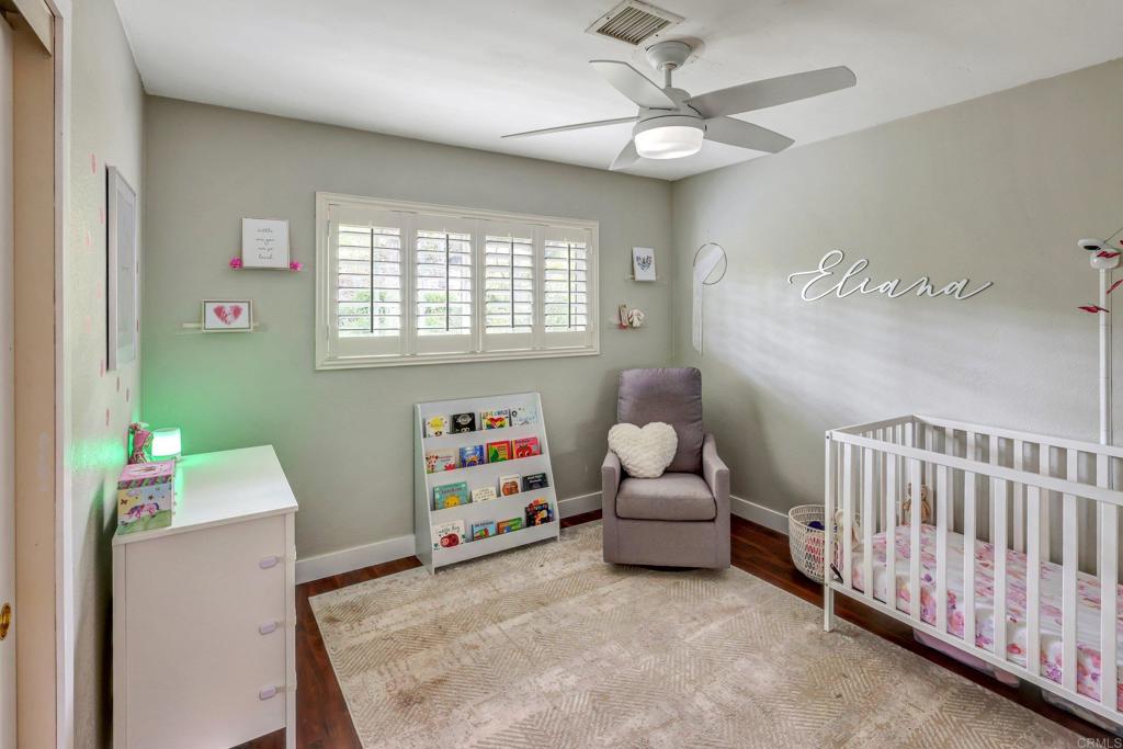 11985 Rocoso Road Lakeside, CA 92040 - Photo 26 of 48 a living room with baby crib furniture and a window