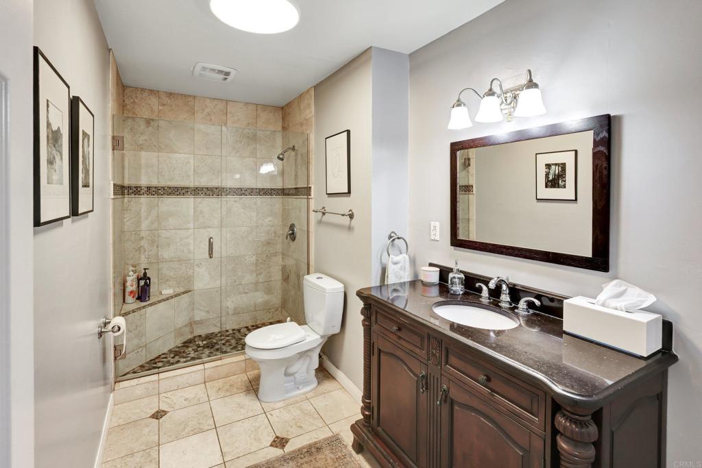 11985 Rocoso Road Lakeside, CA 92040 - Photo 29 of 48 a bathroom with a sink vanity mirror and toilet