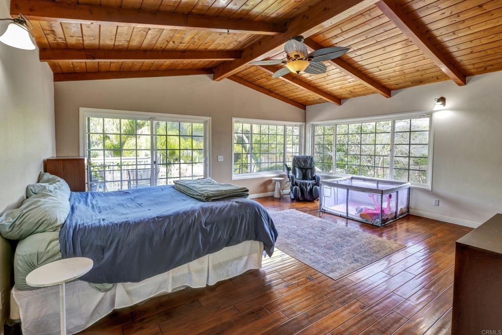 11985 Rocoso Road Lakeside, CA 92040 - Photo 31 of 48 a bed room with a bed and a large window