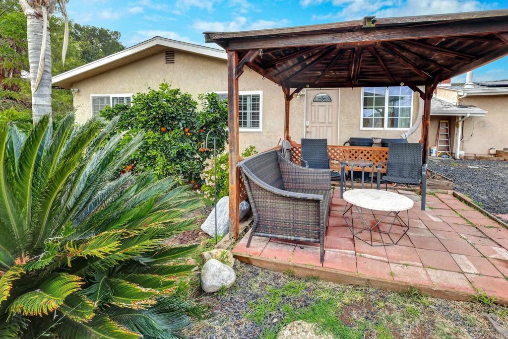 11985 Rocoso Road Lakeside, CA 92040 - Photo 36 of 48 a view of a backyard with table and chairs with wooden fence