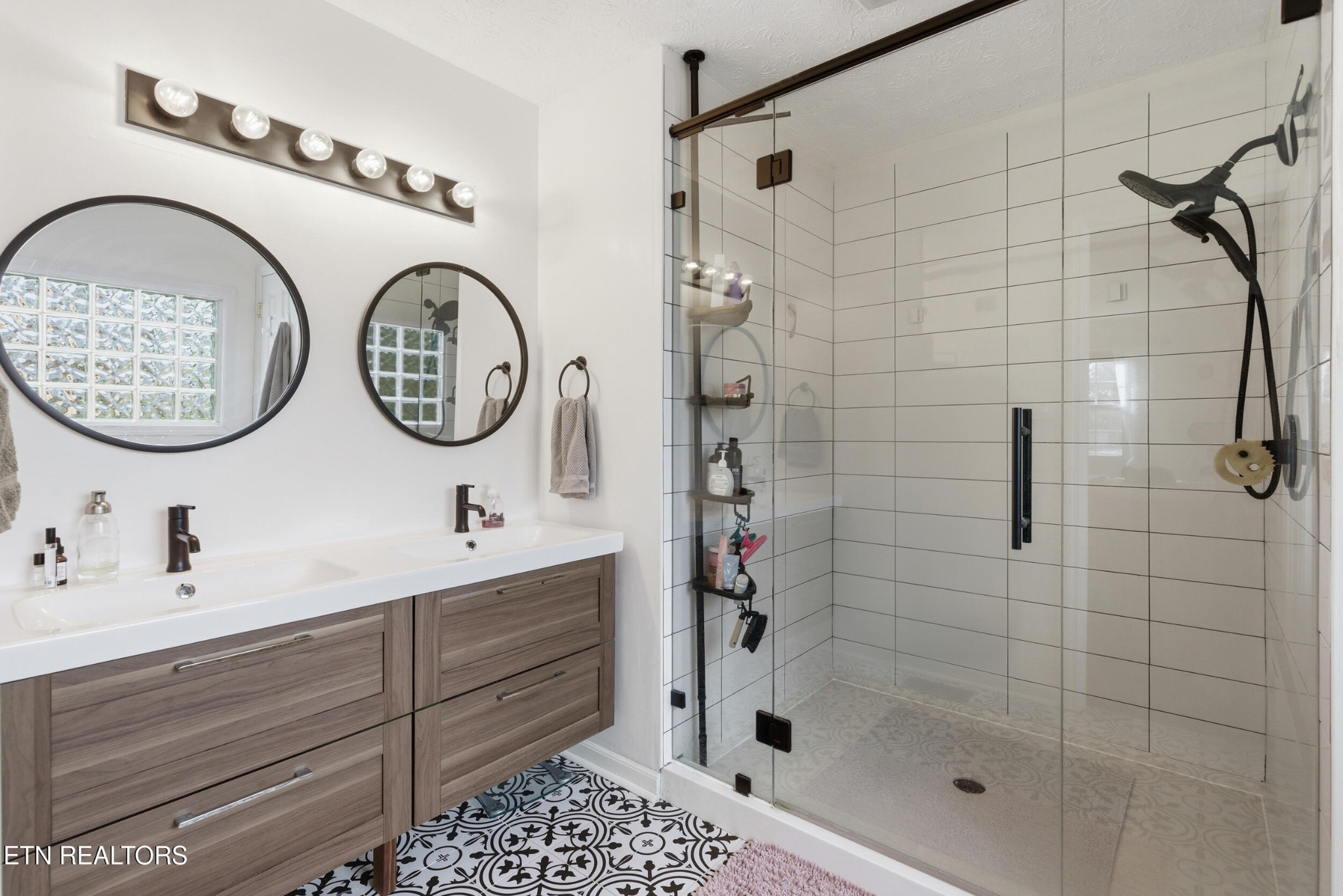 10508 River Ridge Road Knoxville, TN 37922 - Photo 16 of 29 a bathroom with a sink a mirror and a shower