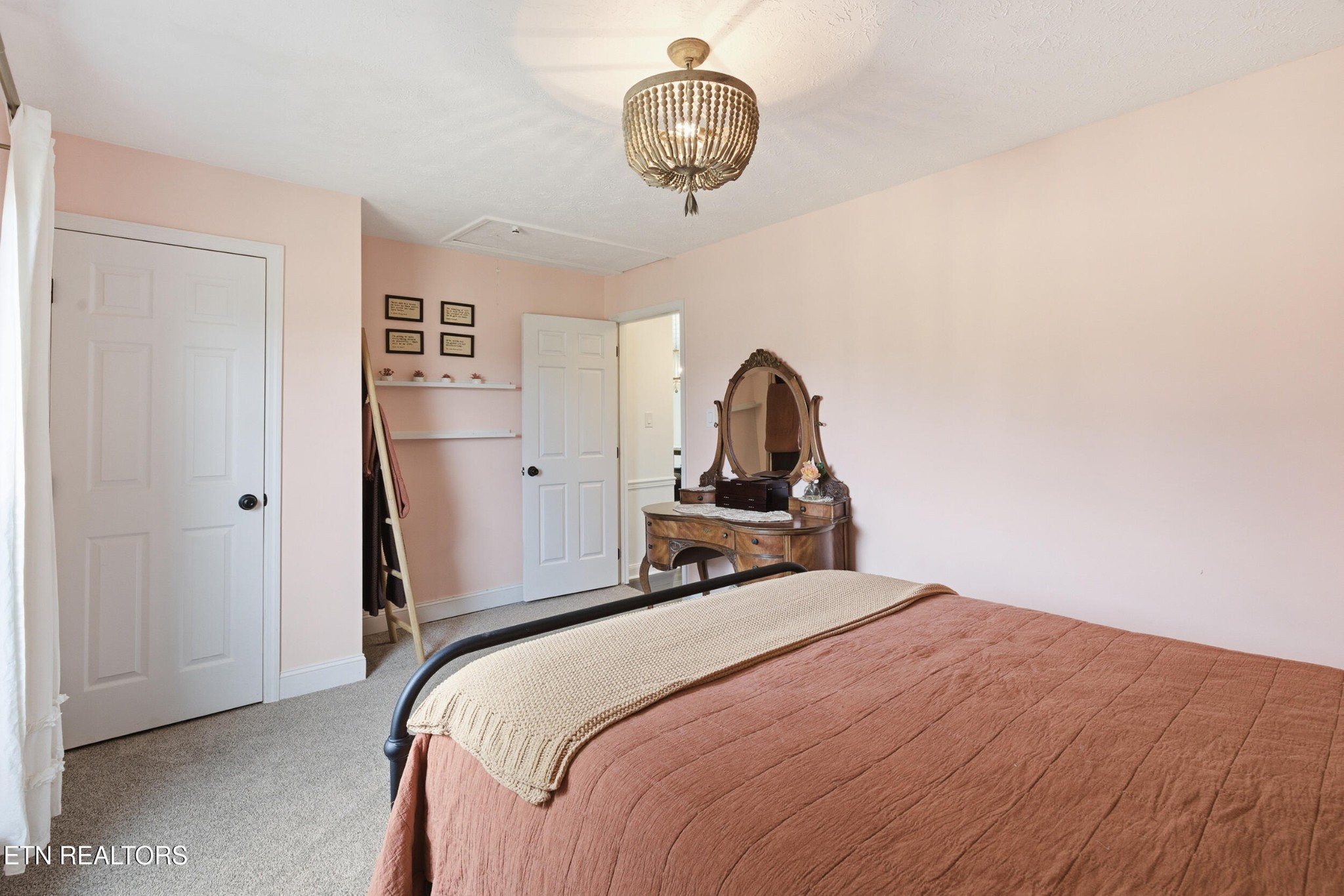 10508 River Ridge Road Knoxville, TN 37922 - Photo 20 of 29 a bedroom with a bed and a chandelier