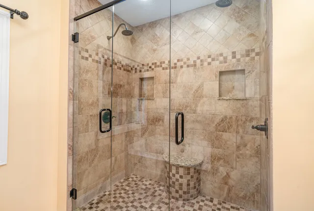 a bed sitting in a spacious bedroom next to a window