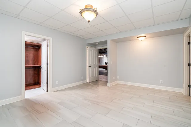 a view of a big room with lounge chair and windows