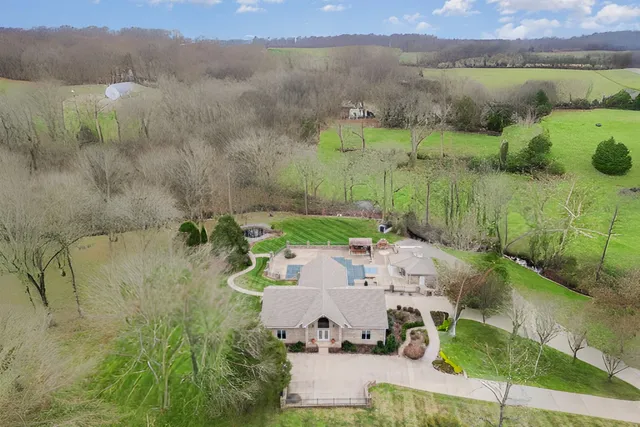 a view of a living room with wooden floor and large windows