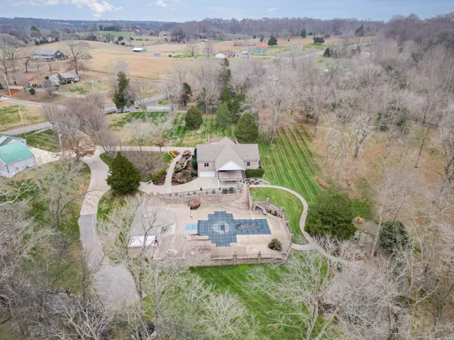 a view of a house with a yard covered with snow in the background