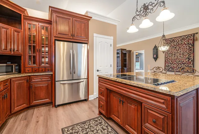 a bathroom with a granite countertop sink a mirror and a shower