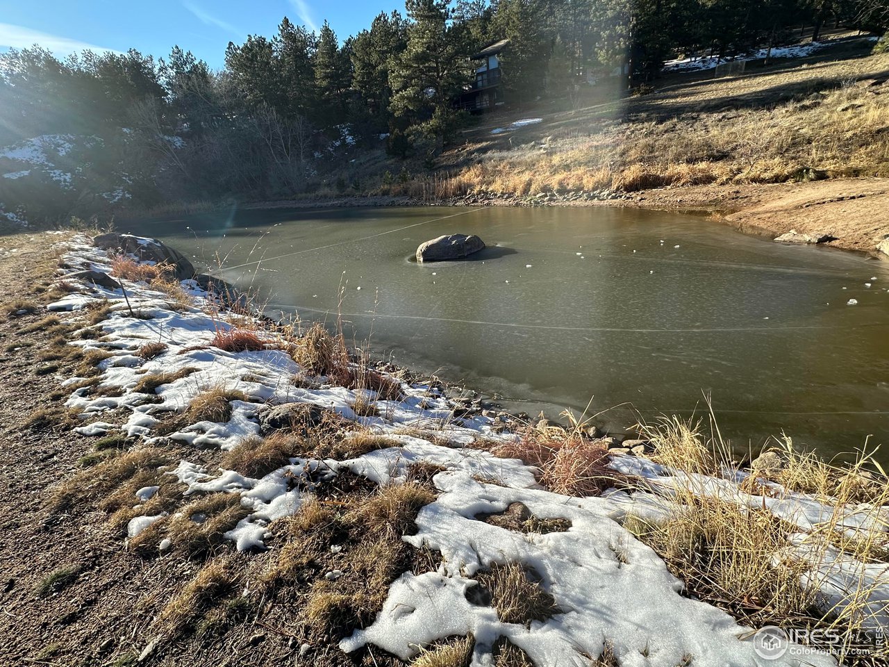 0 Tbd) Pima Road Lyons, CO 80540 - Photo 26 of 31 a blue swimming pool with a lake view