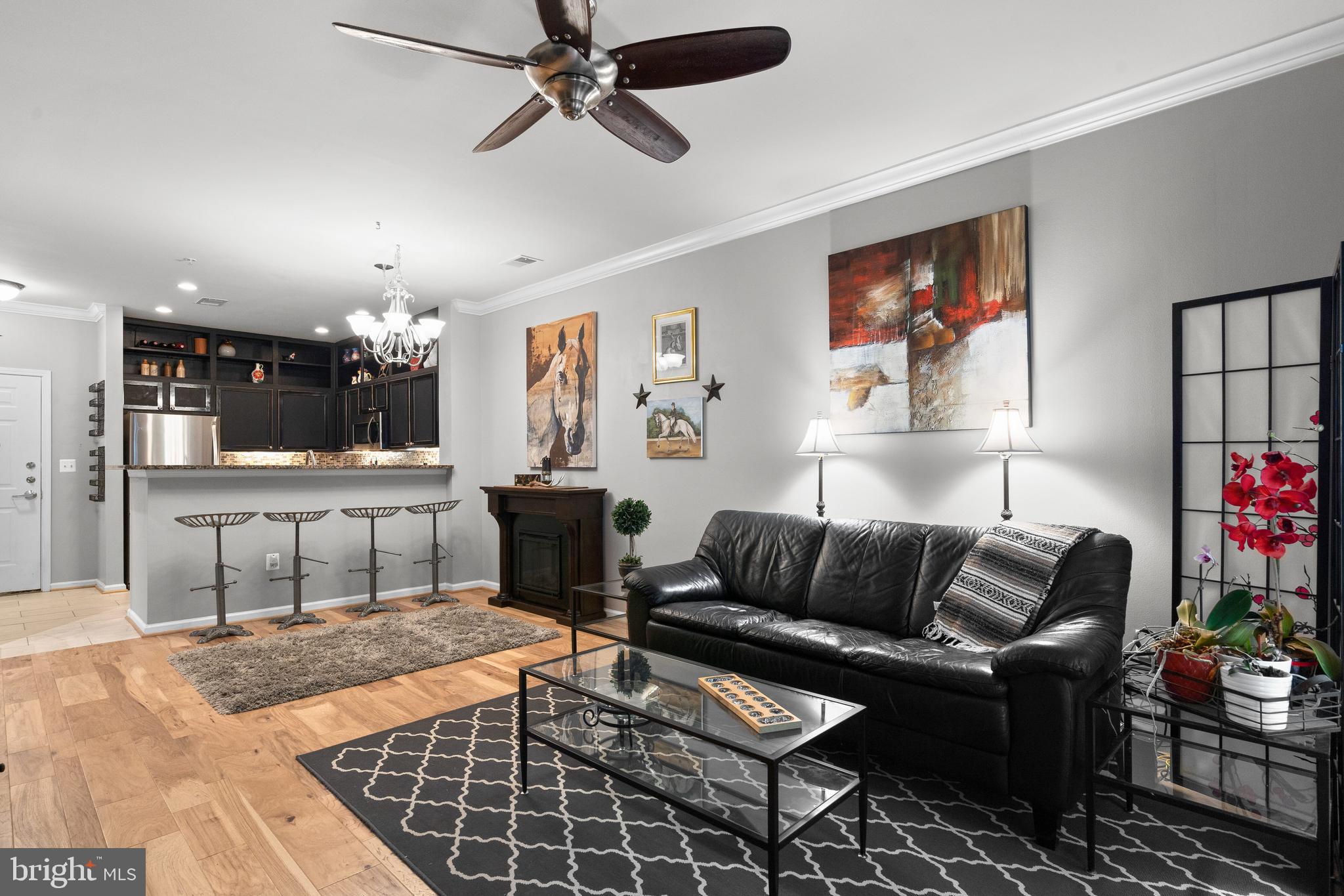 12000 Market Street, Unit 131 Reston, VA 20190 - Photo 11 of 41 a living room with furniture and kitchen view