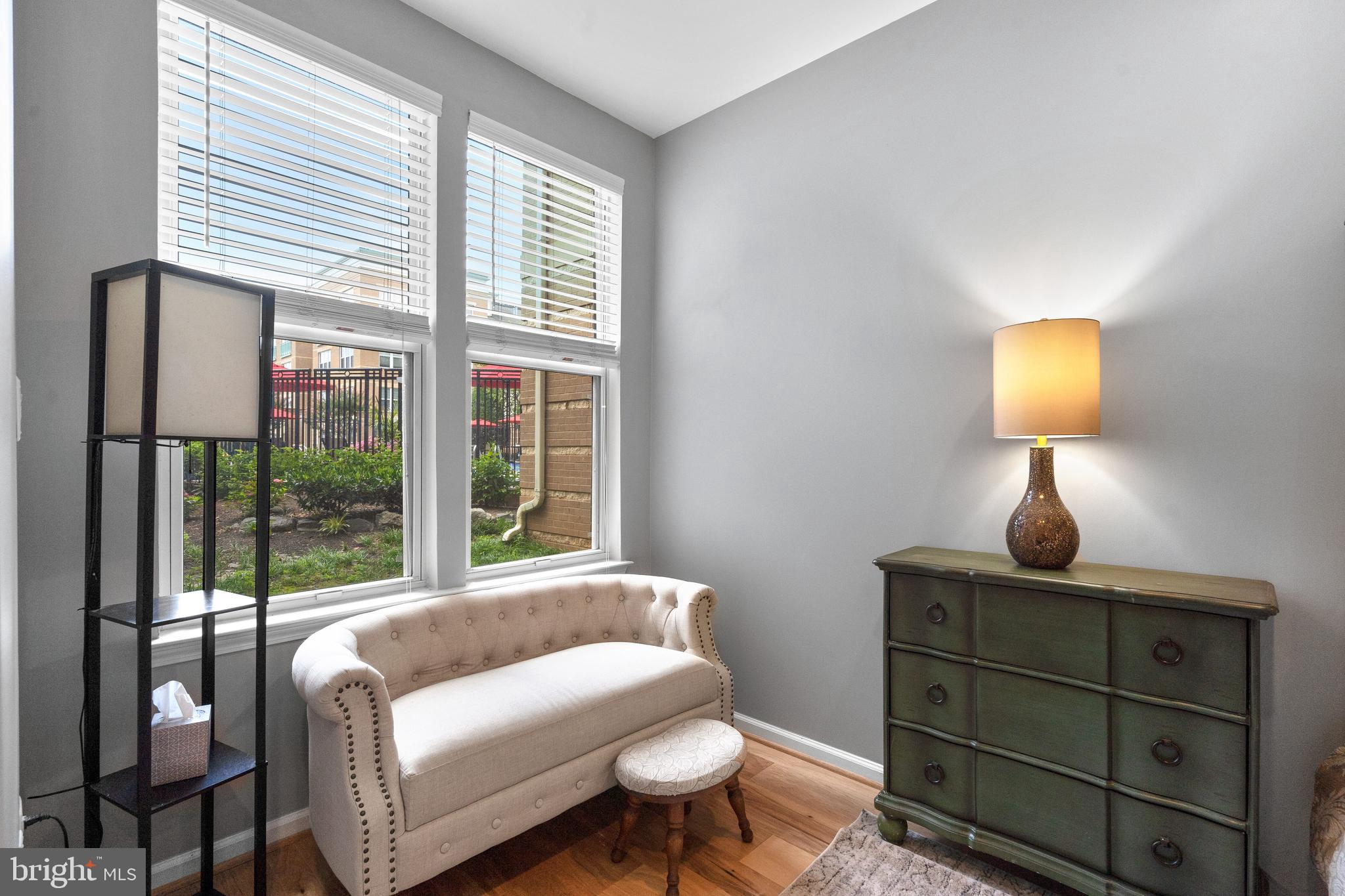 12000 Market Street, Unit 131 Reston, VA 20190 - Photo 27 of 41 a living room with furniture and a lamp