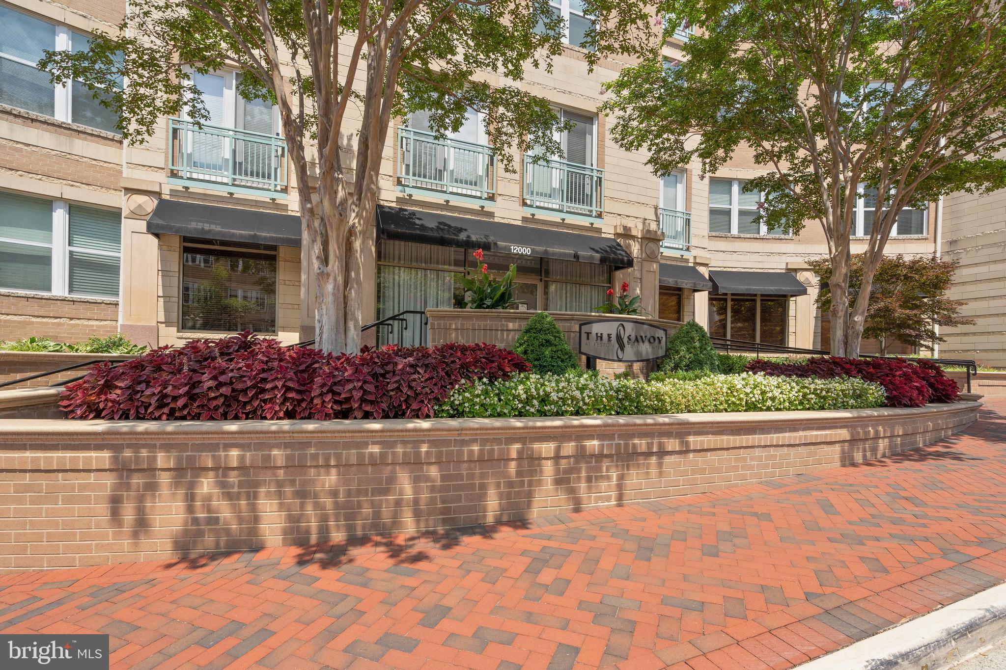 12000 Market Street, Unit 131 Reston, VA 20190 - Photo 6 of 41 front view of a house with a yard