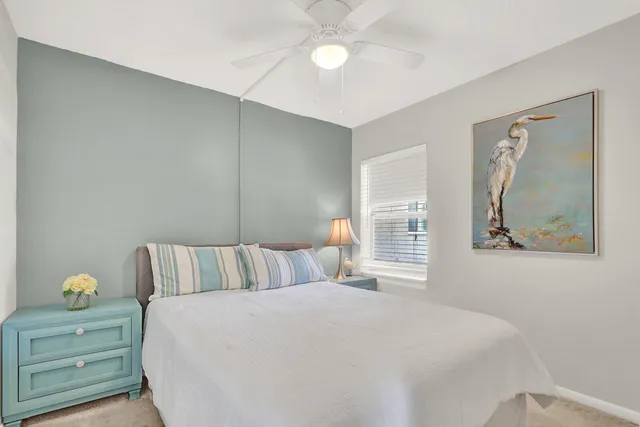 a bedroom with a bed and lamp