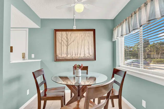 a view of a dining room with furniture and a window