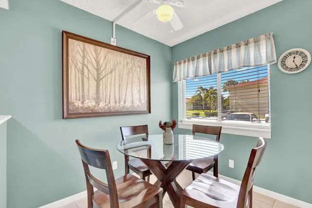 a view of a dining room with furniture large window and wooden floor