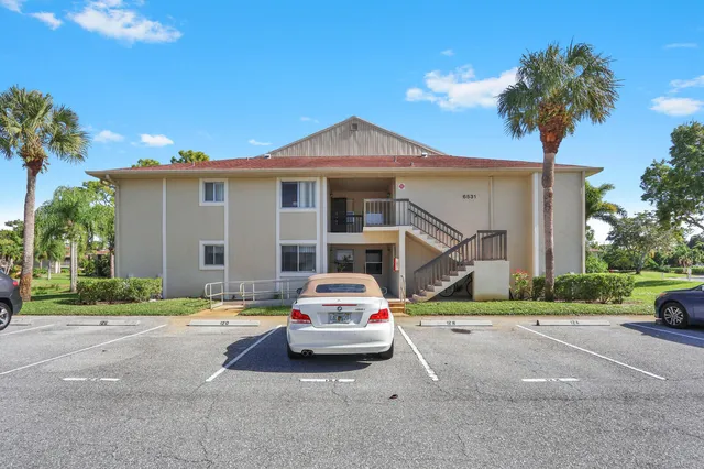 a car parked in front of white house