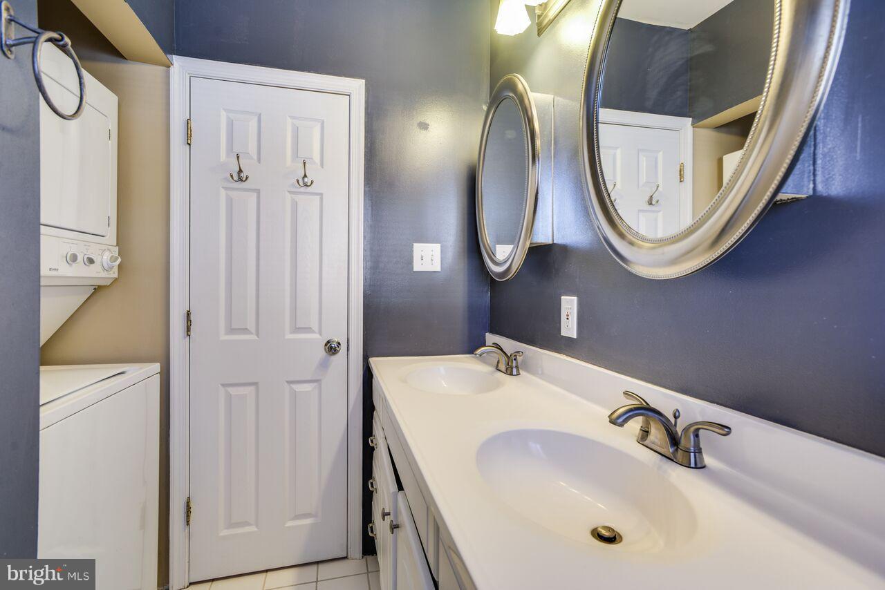 204 Skyhill Road, Unit 7 Alexandria, VA 22314 - Photo 15 of 20 a bathroom with a sink a mirror and a shower
