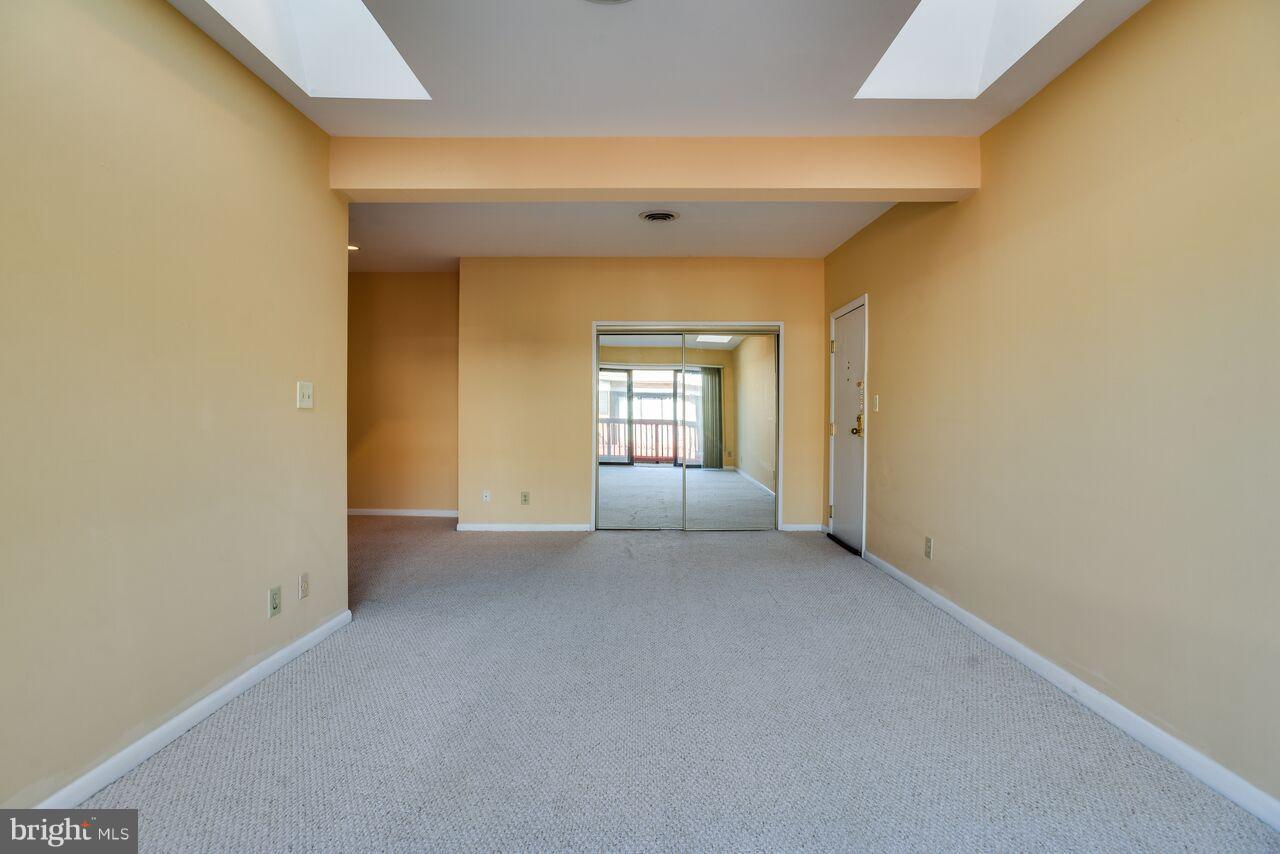204 Skyhill Road, Unit 7 Alexandria, VA 22314 - Photo 6 of 20 a view of a big room with windows and cabinet